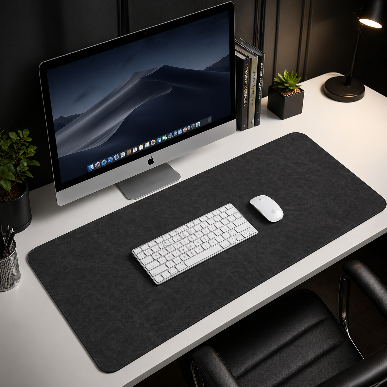 Modern office desk setup with computer monitor, keyboard, mouse, and desk pad.