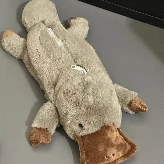 Plush toy resembling a platypus on a gray surface