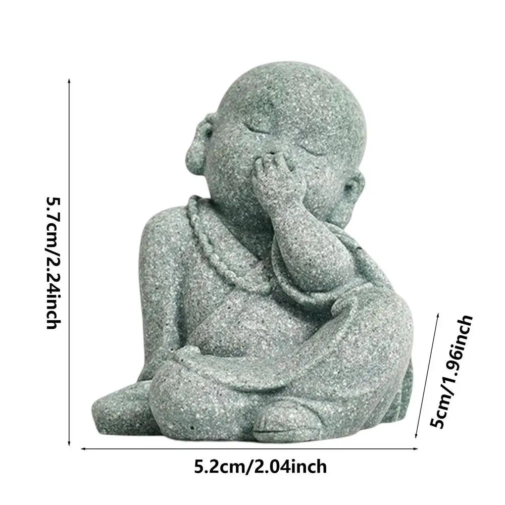Small stone statue of a child with measurements on a white background