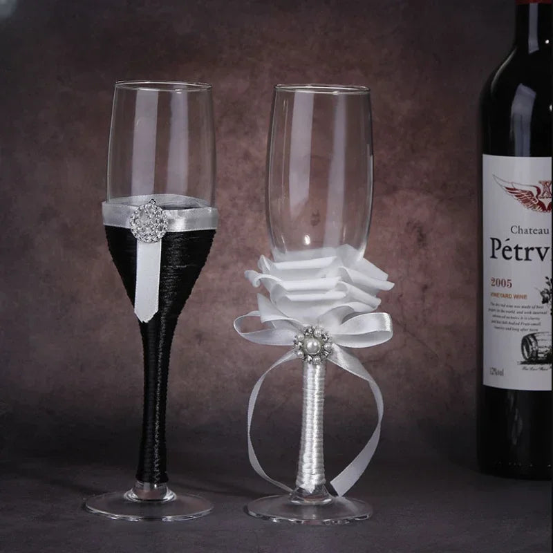 Two decorative wine glasses with ribbons and a bottle of Chateau Pétrus in the background.