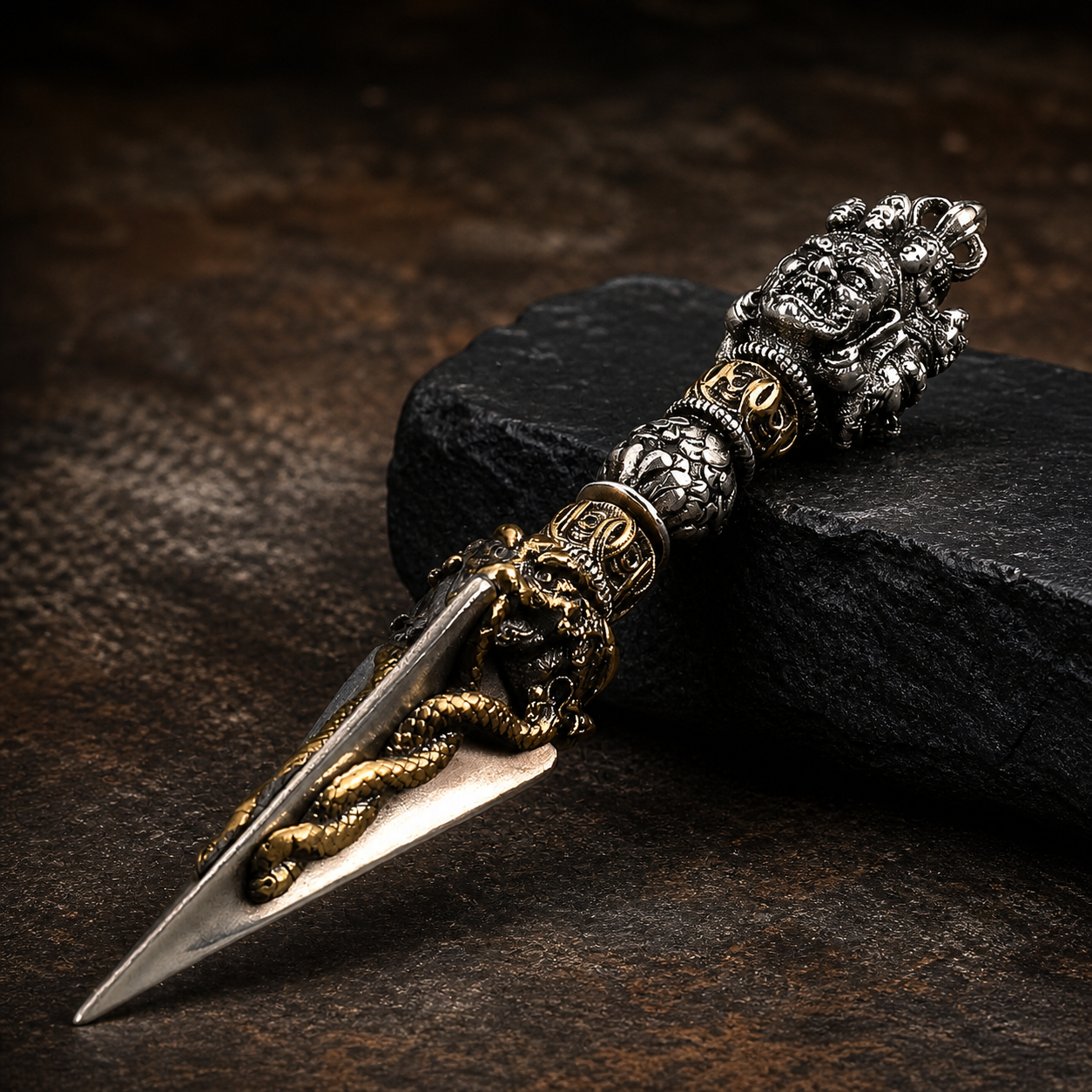 Decorative dagger with ornate handle on a dark surface