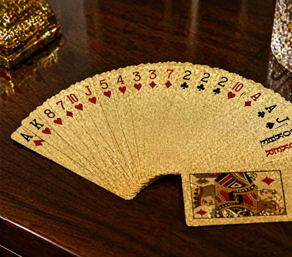 Gold playing cards fanned out on a wooden surface