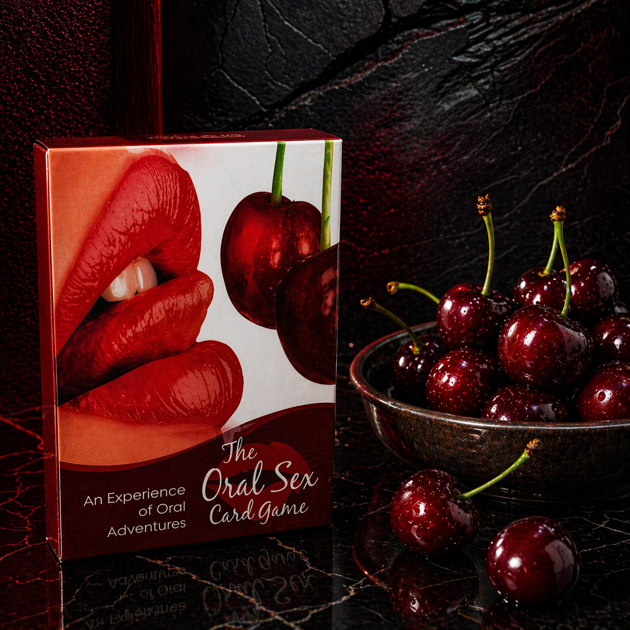 Card game box titled 'The Oral Sex Card Game' with cherries on a dark surface
