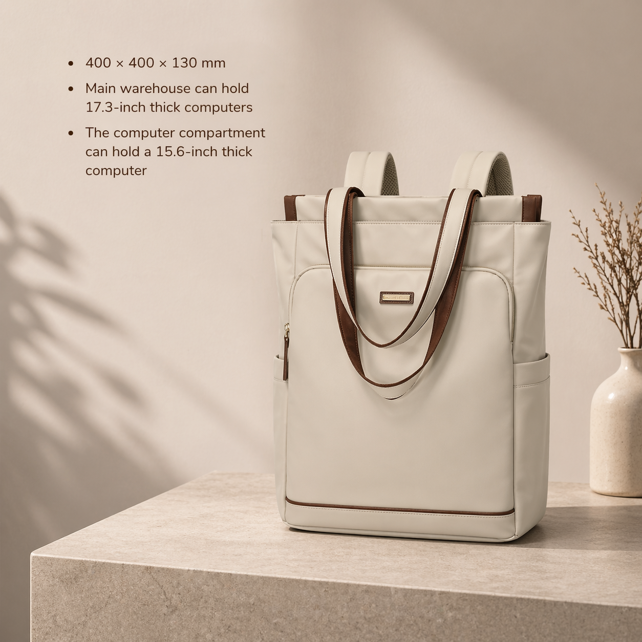 White tote bag with brown handles on a light wooden surface with a vase in the background