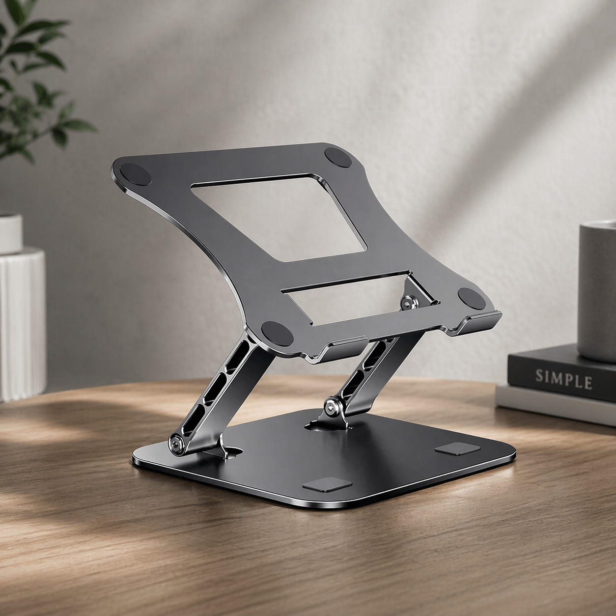 Gray adjustable laptop stand on a wooden surface with a neutral background