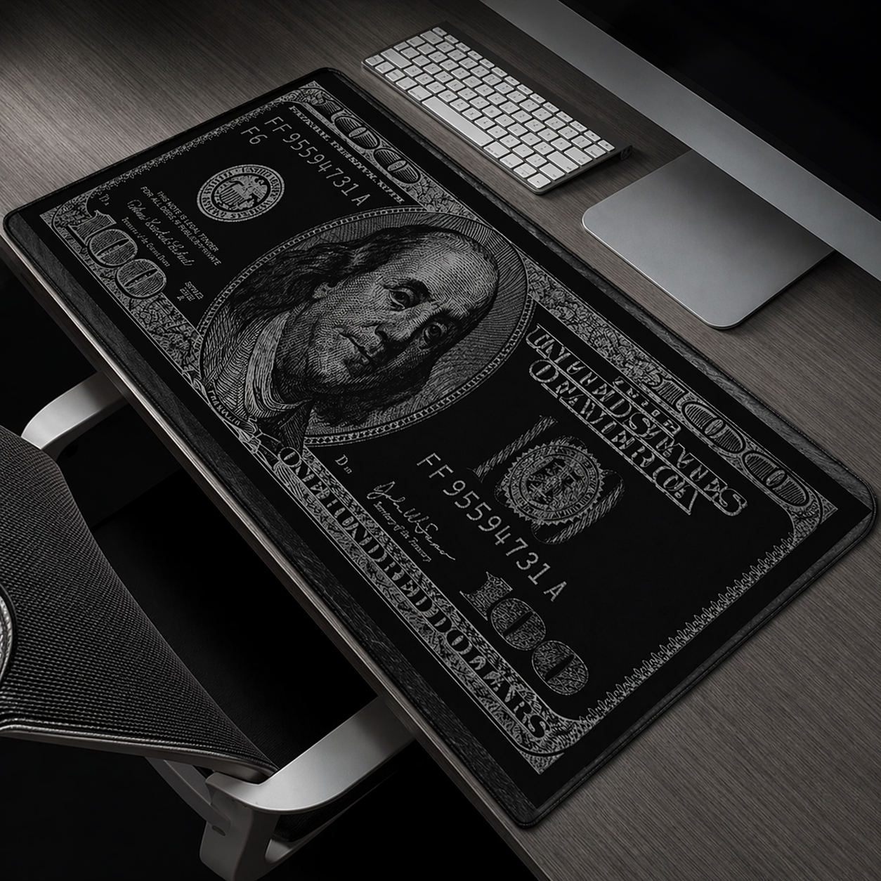 Black and white dollar bill design desk mat on a wooden desk with office items.