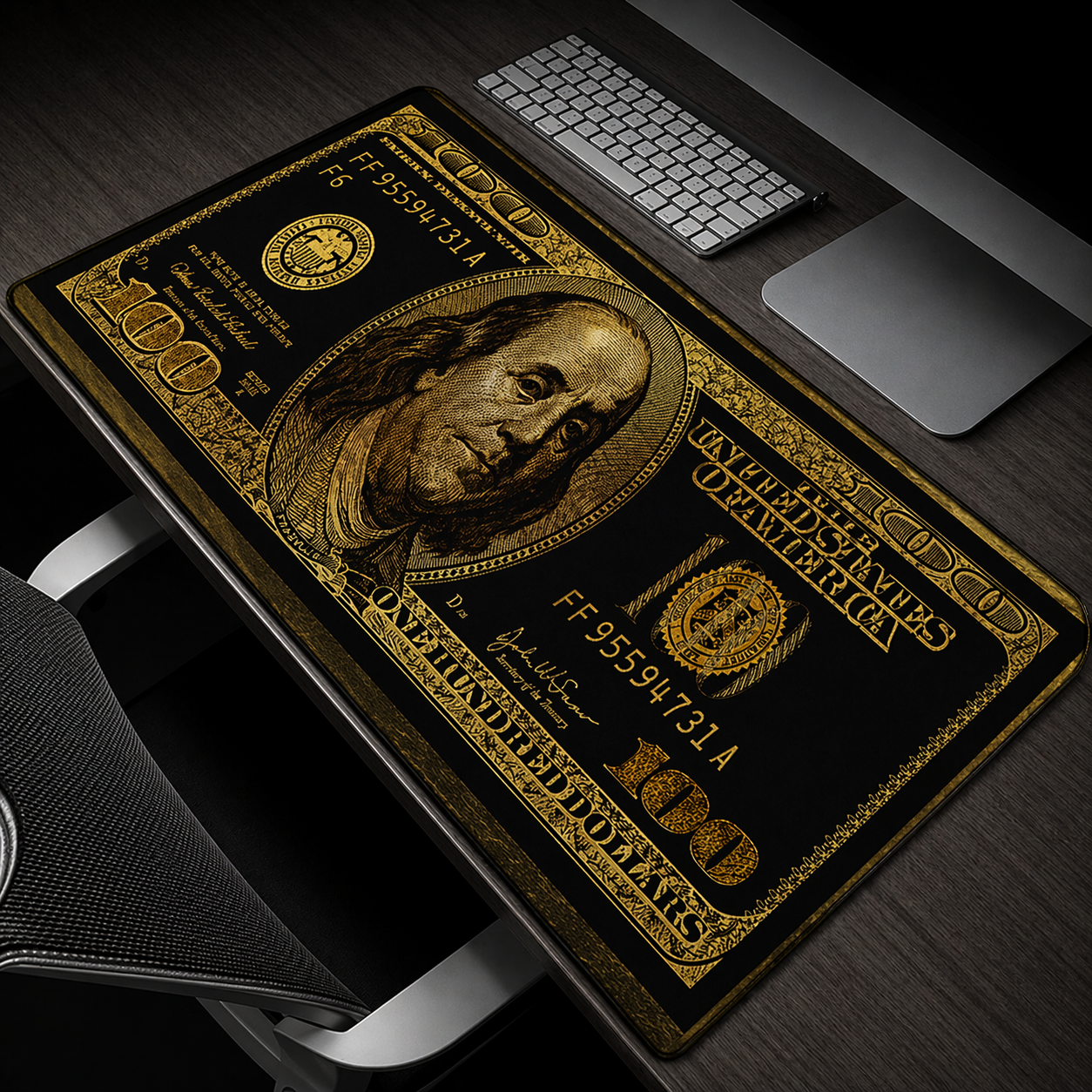 Desk mat designed like a $100 bill with a computer setup on a desk.