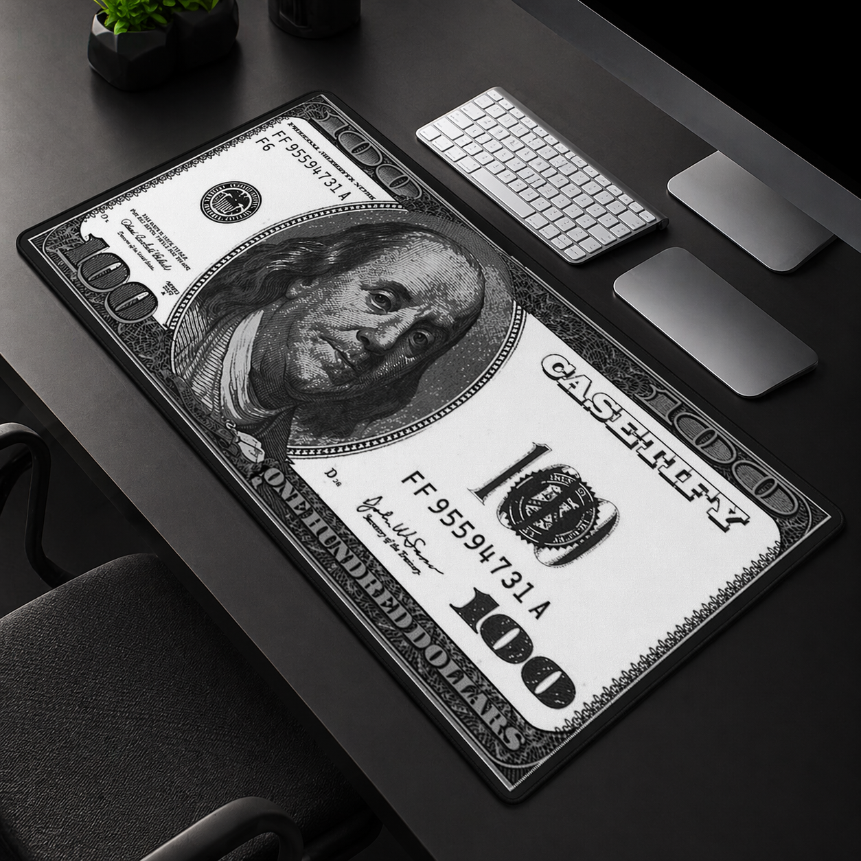Desk setup with a large dollar bill design mouse pad.