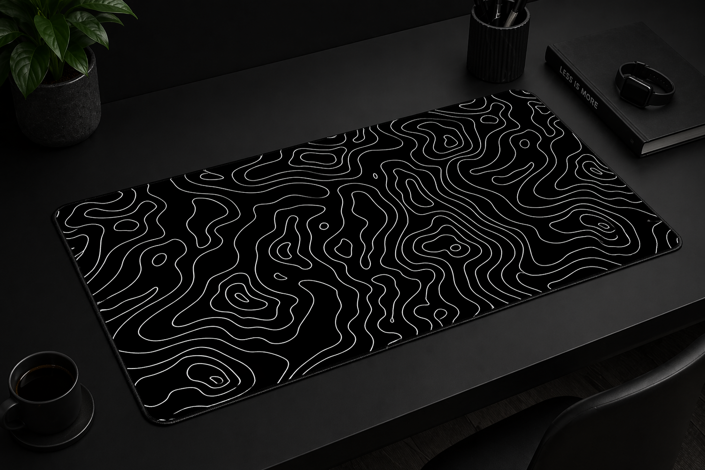 Black desk mat with wavy line pattern on a dark surface