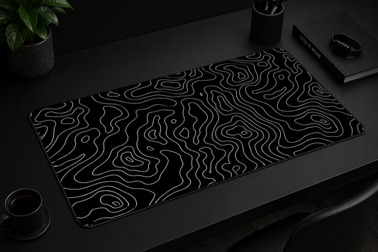 Black desk mat with wavy line pattern on a dark surface