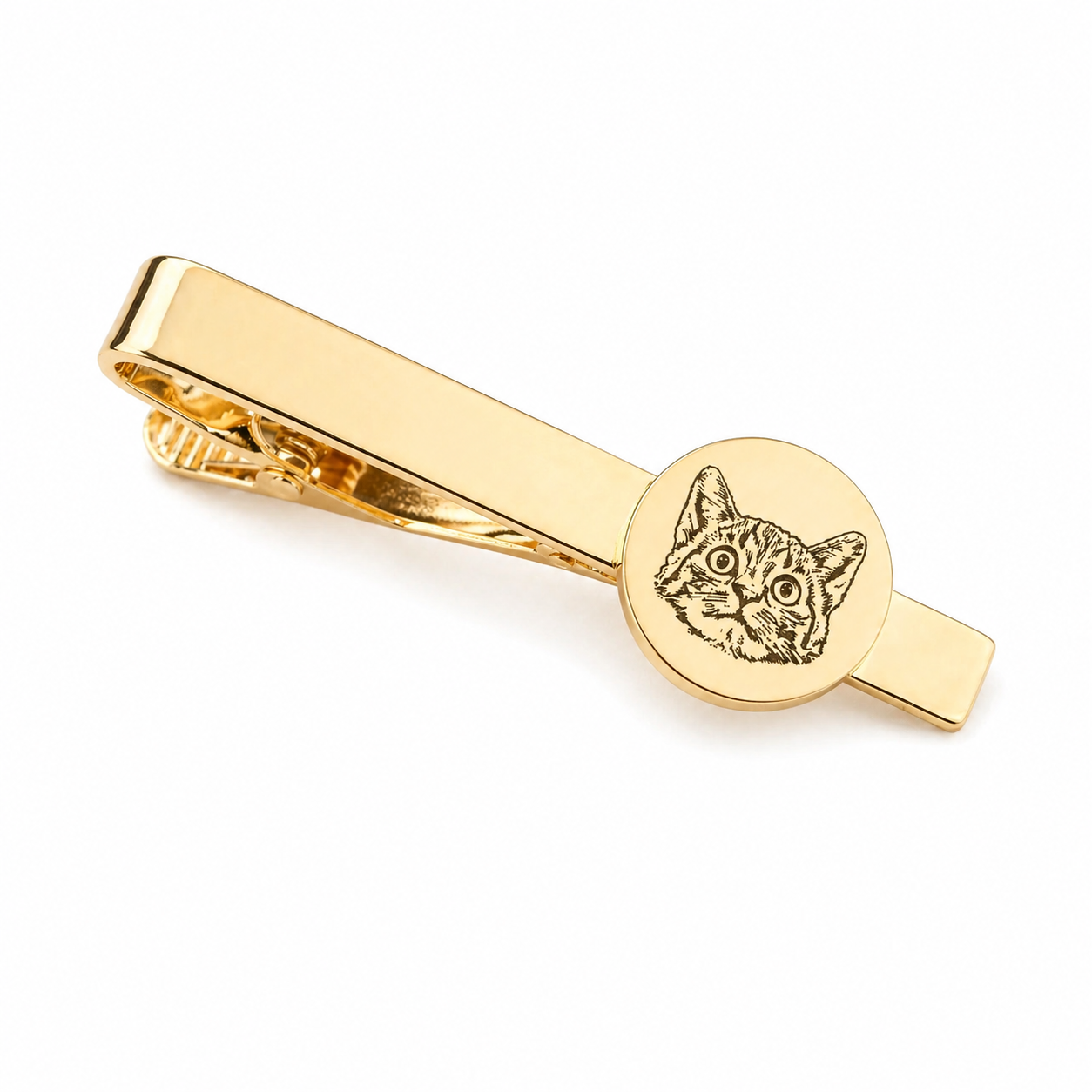 Gold tie clip with cat design on a white background