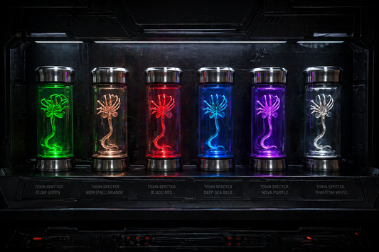 Set of six illuminated glass vials with alien creature designs on a dark background