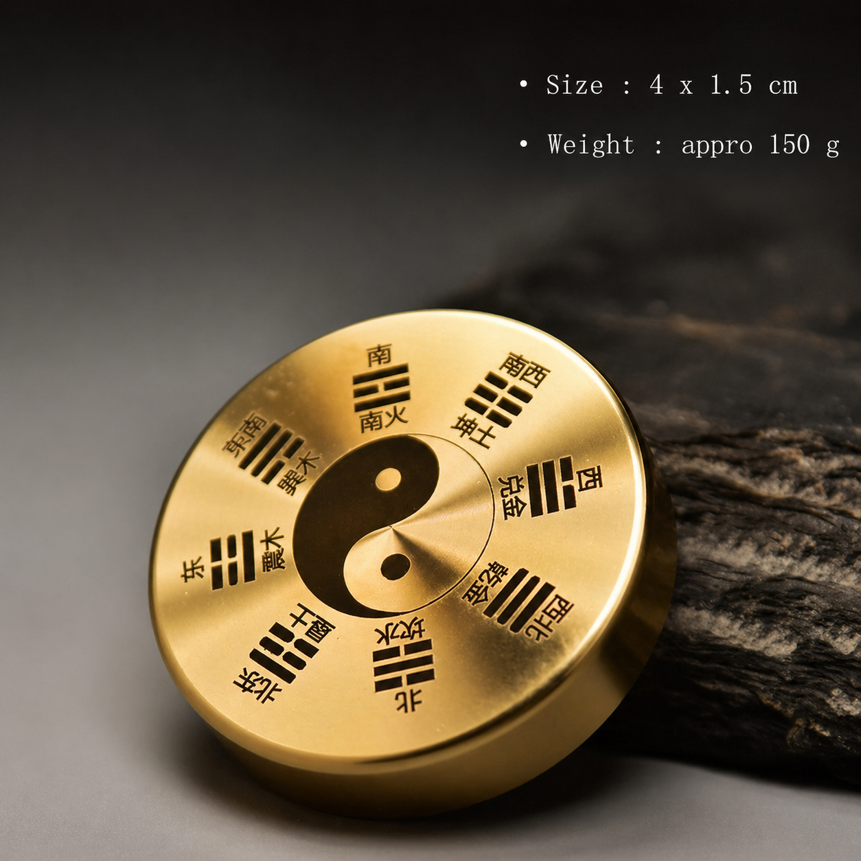 Gold circular object with Chinese characters and yin-yang symbol on a dark background