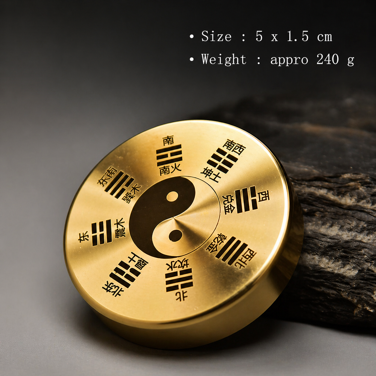 Gold circular object with Chinese characters and a yin-yang symbol on a dark background