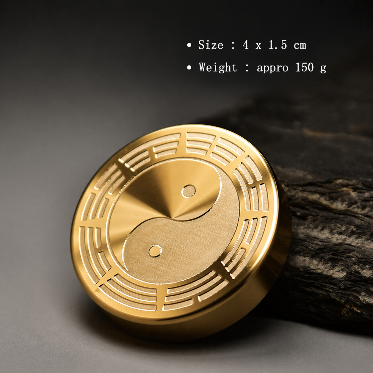 Gold circular object with yin-yang design on a dark background