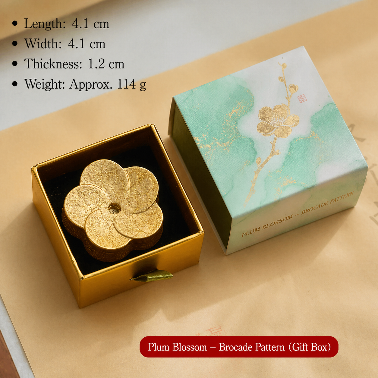 Gold plum blossom-shaped object in a gift box with product details on a beige background