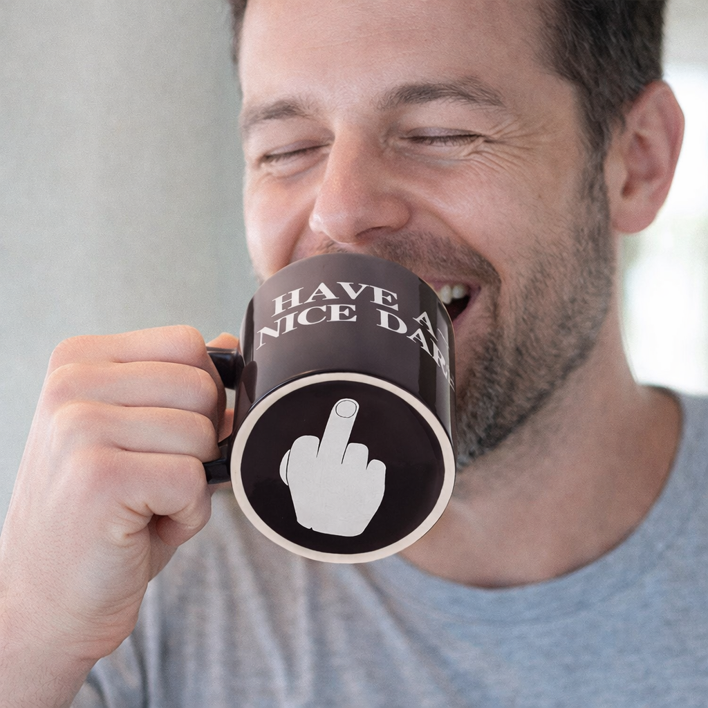 Man holding a mug with a humorous design and text.