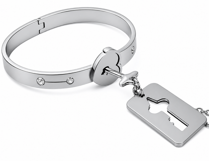 Silver bracelet with key-shaped charm on a white background