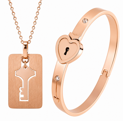 Rose gold necklace with key pendant and heart-shaped lock bracelet on a white background