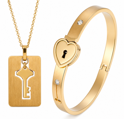 Gold necklace with key pendant and gold heart-shaped bracelet on a white background