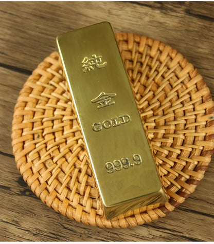 Gold bar with 'GOLD' and '999.9' marking on a woven mat.