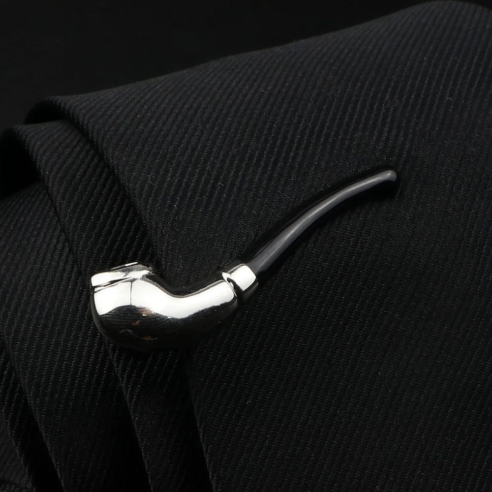 Tie clip shaped like a pipe on a black textured background