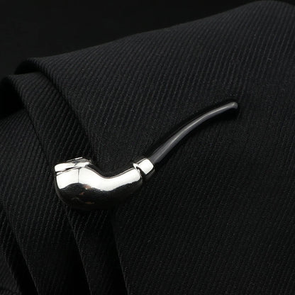 Tie clip shaped like a pipe on a black textured background