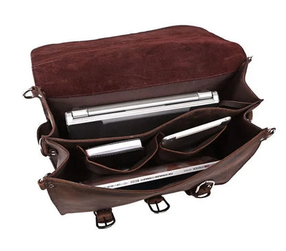 Brown leather bag with compartments and silver items inside on a white background