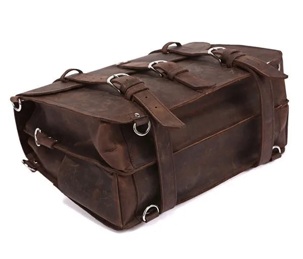 Brown leather bag with multiple straps on a white background