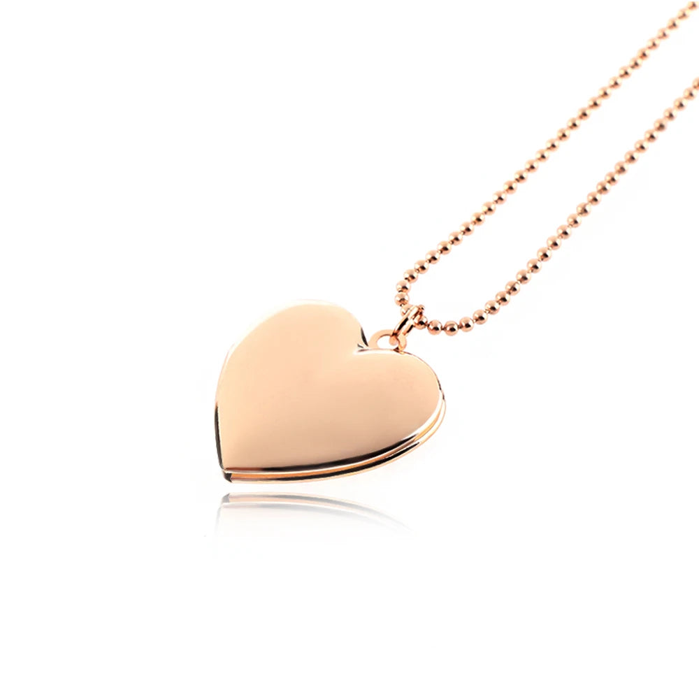 Rose gold heart-shaped pendant on a chain against a white background