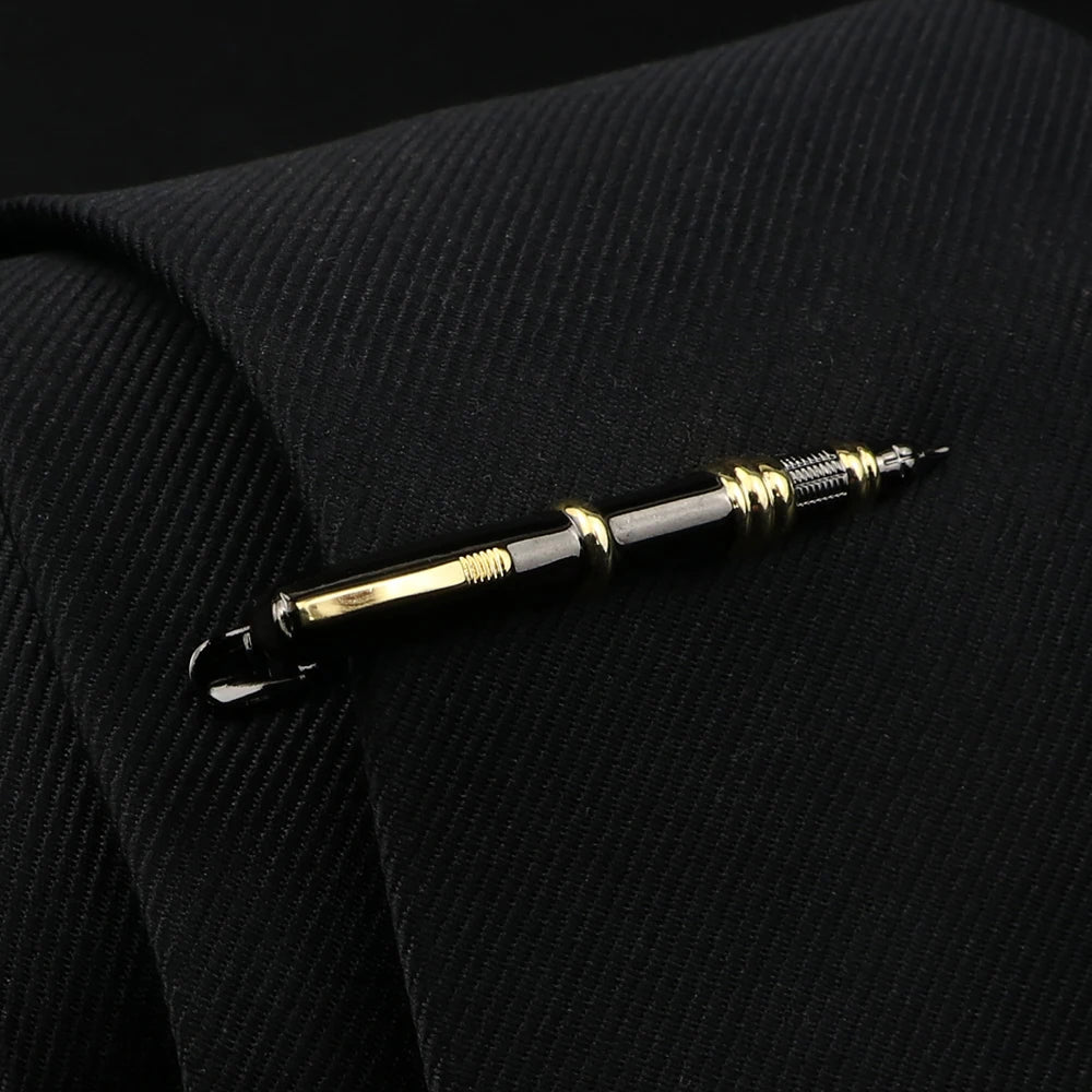 Gold and silver pen on a black textured surface