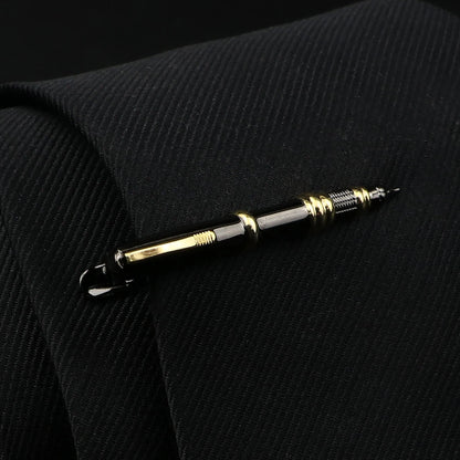 Gold and silver pen on a black textured surface