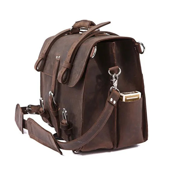 Brown leather backpack with multiple straps on a white background