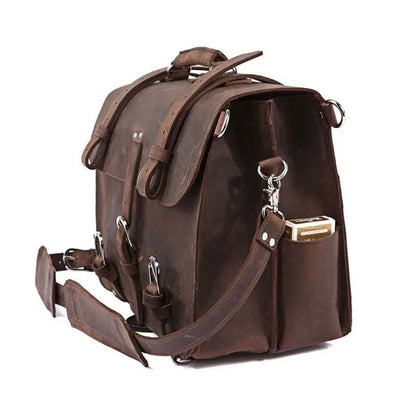Brown leather backpack with multiple straps on a white background