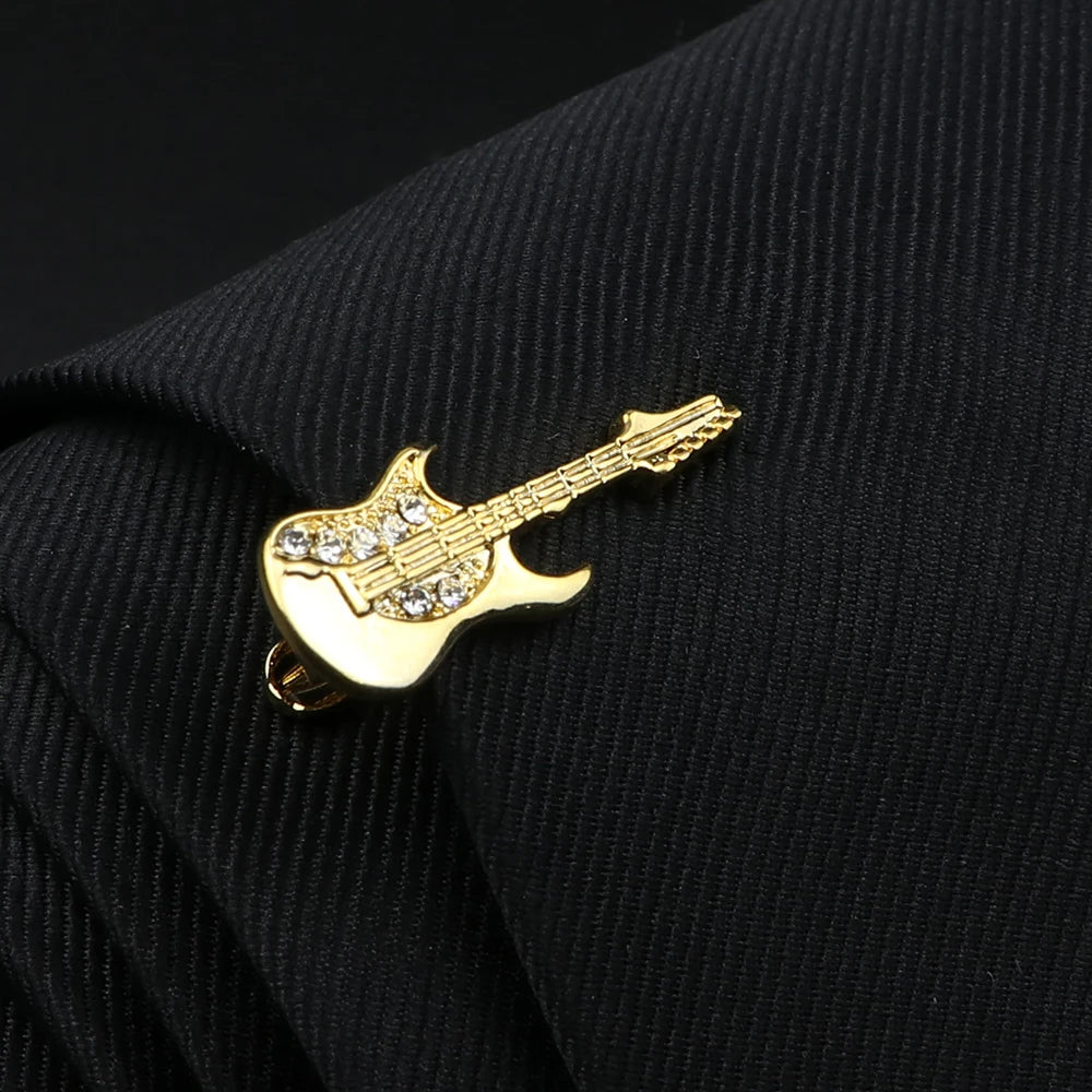 Gold guitar-shaped lapel pin on a black jacket