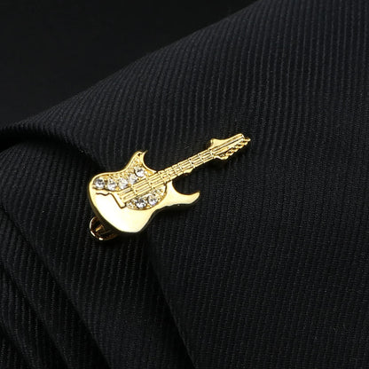 Gold guitar-shaped lapel pin on a black jacket