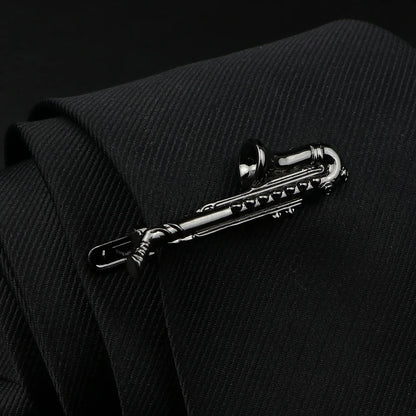 Silver saxophone tie clip on a black suit background
