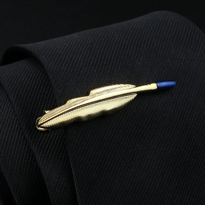 Gold feather-shaped lapel pin on a black suit jacket