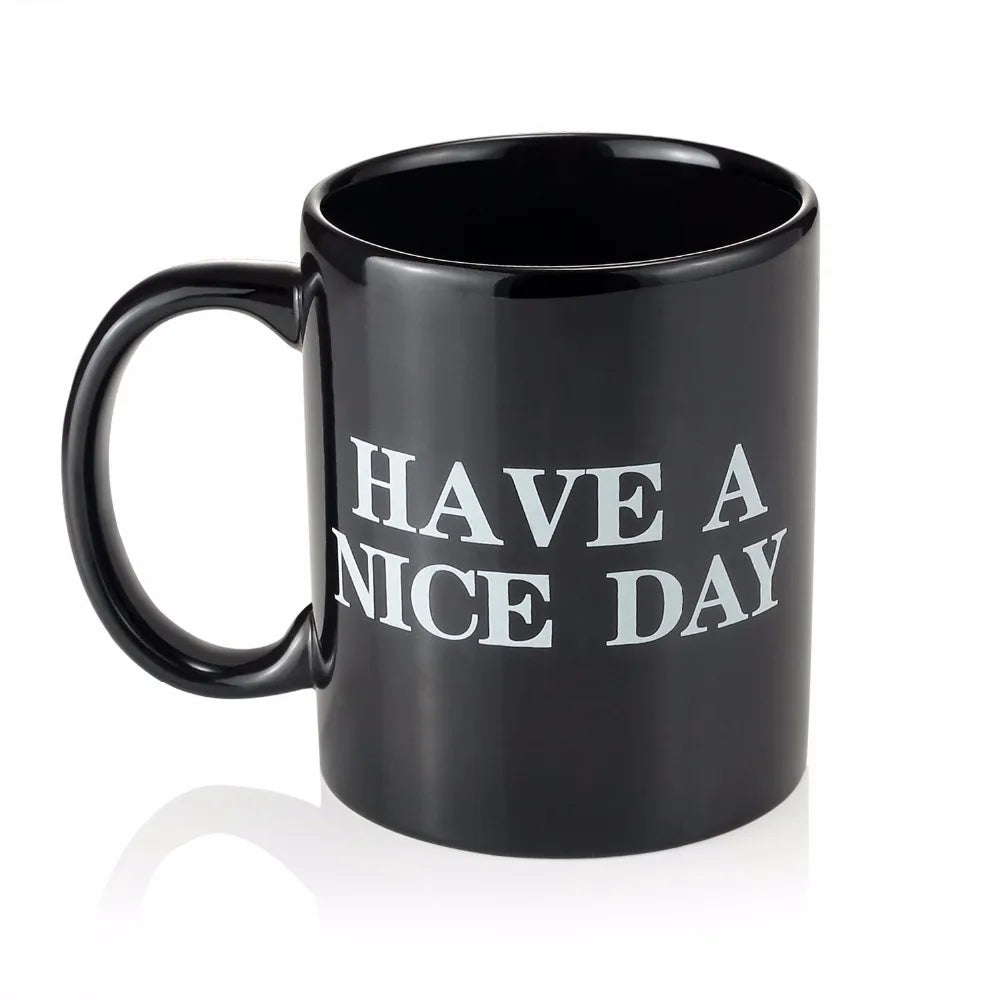 Black mug with 'HAVE A NICE DAY' text on a white background