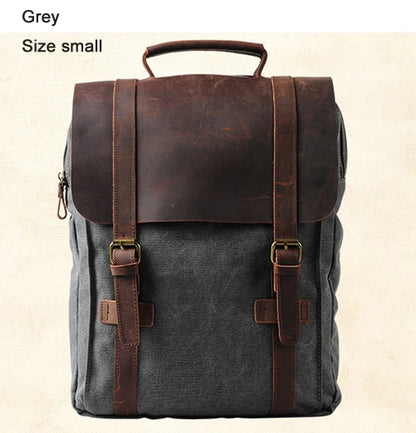 Gray backpack with brown leather straps on a beige background