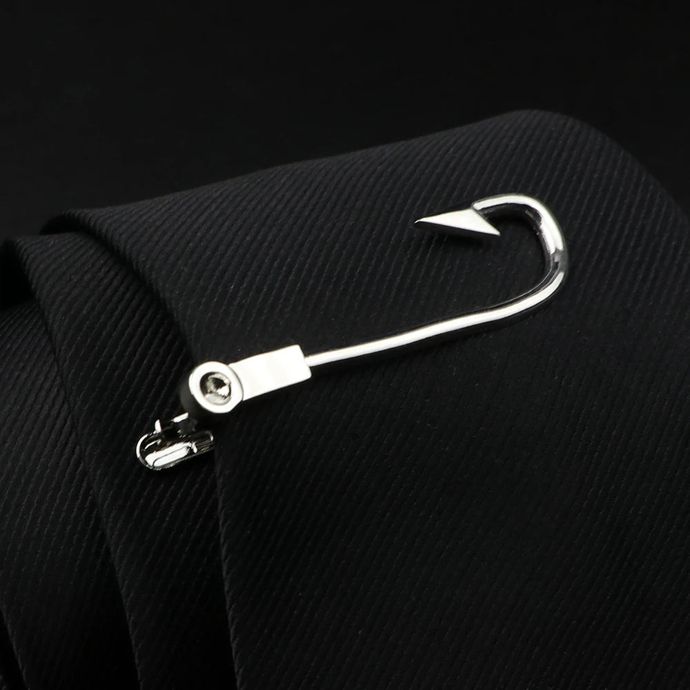 Metallic fishing hook attached to a black suit jacket on a dark background