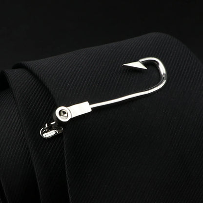Metallic fishing hook attached to a black suit jacket on a dark background