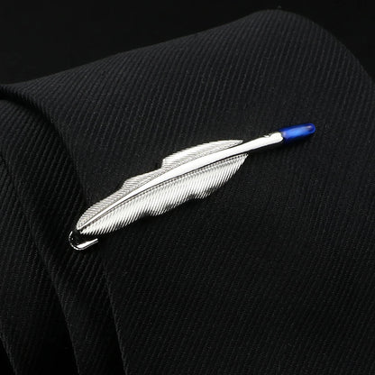 Feather-shaped lapel pin on a black suit jacket