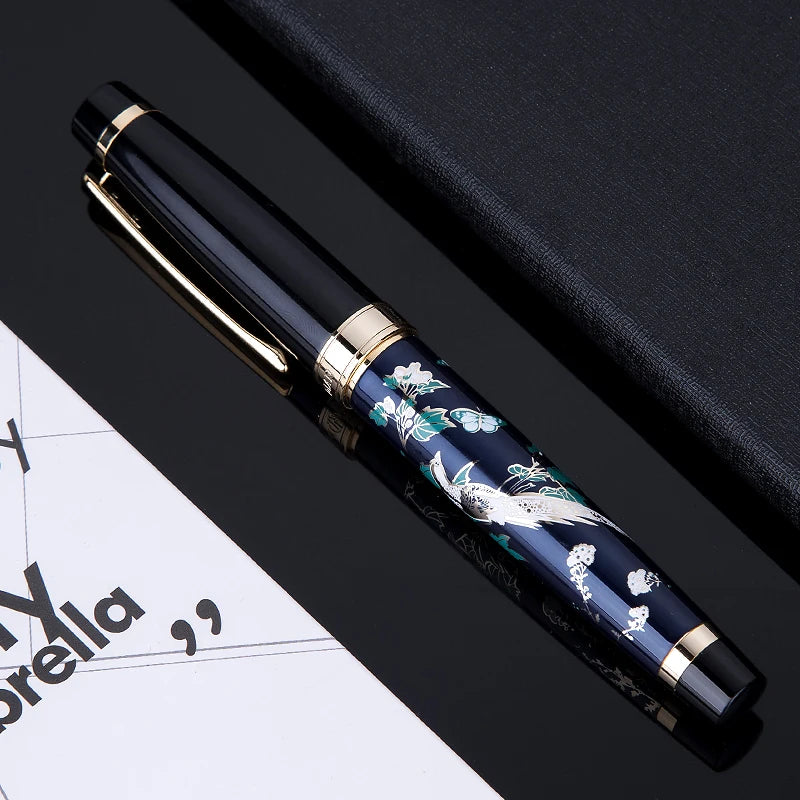Decorative pen with floral design on a black surface
