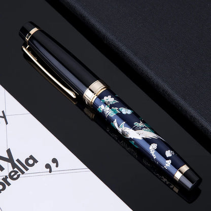 Decorative pen with floral design on a black surface
