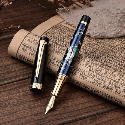 Two fountain pens on a wooden surface with an old book