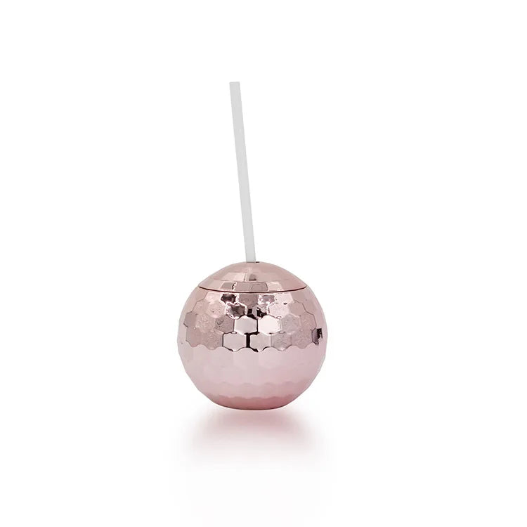 Rose gold disco ball with a straw on a white background