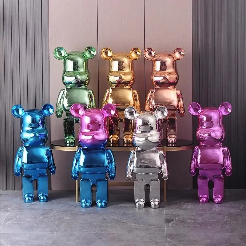 Colorful bear-shaped figurines on a reflective surface with a neutral background