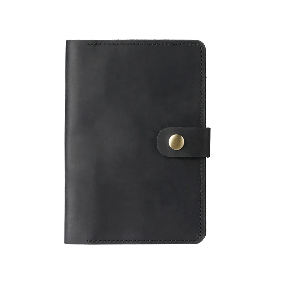 Black leather notebook with a gold buckle on a white background