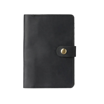 Black leather notebook with a gold buckle on a white background